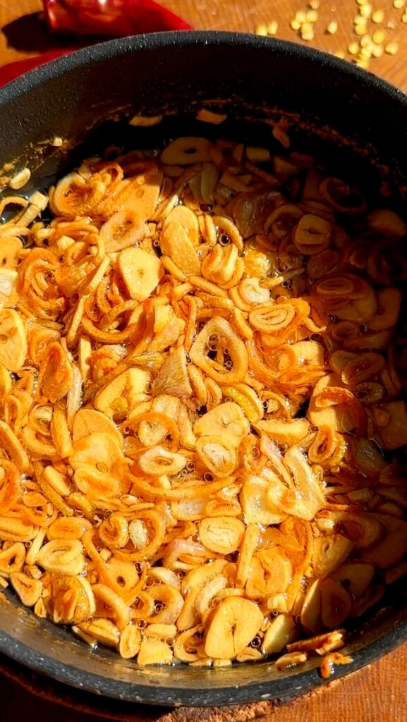 stirring occasionally, until the shallots and garlic turn golden brown and crispy