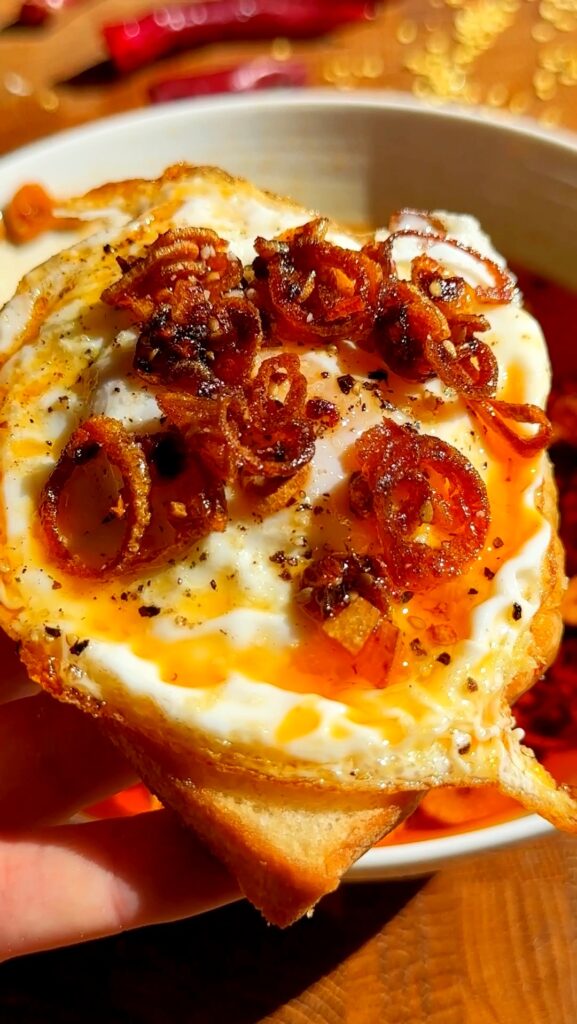 Drizzle over boiled or fried eggs for a spicy, savory twist