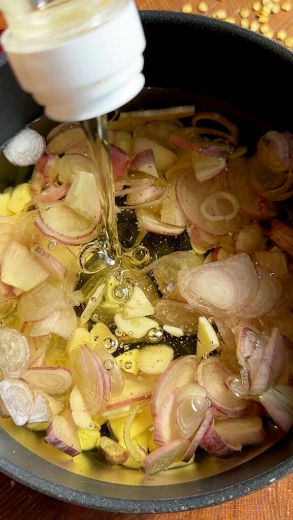 Pour the sunflower oil over shallots and garlic