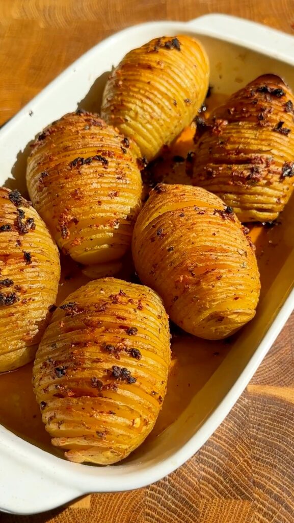 Arrange the potatoes on a parchment-lined baking tray. Bake for 40-45 minutes or until the potatoes are tender and the edges are golden and crispy.