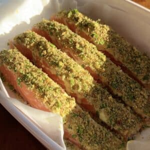 Salmon fillets topped with a pistachio breadcrumb crust before baking.