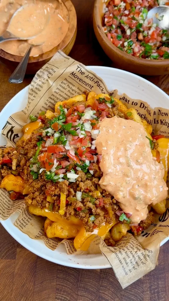 Fresh salsa, creamy burger sauce, and avocado drizzle added to Cheesy Loaded Taco Fries for a rich, flavorful finish.